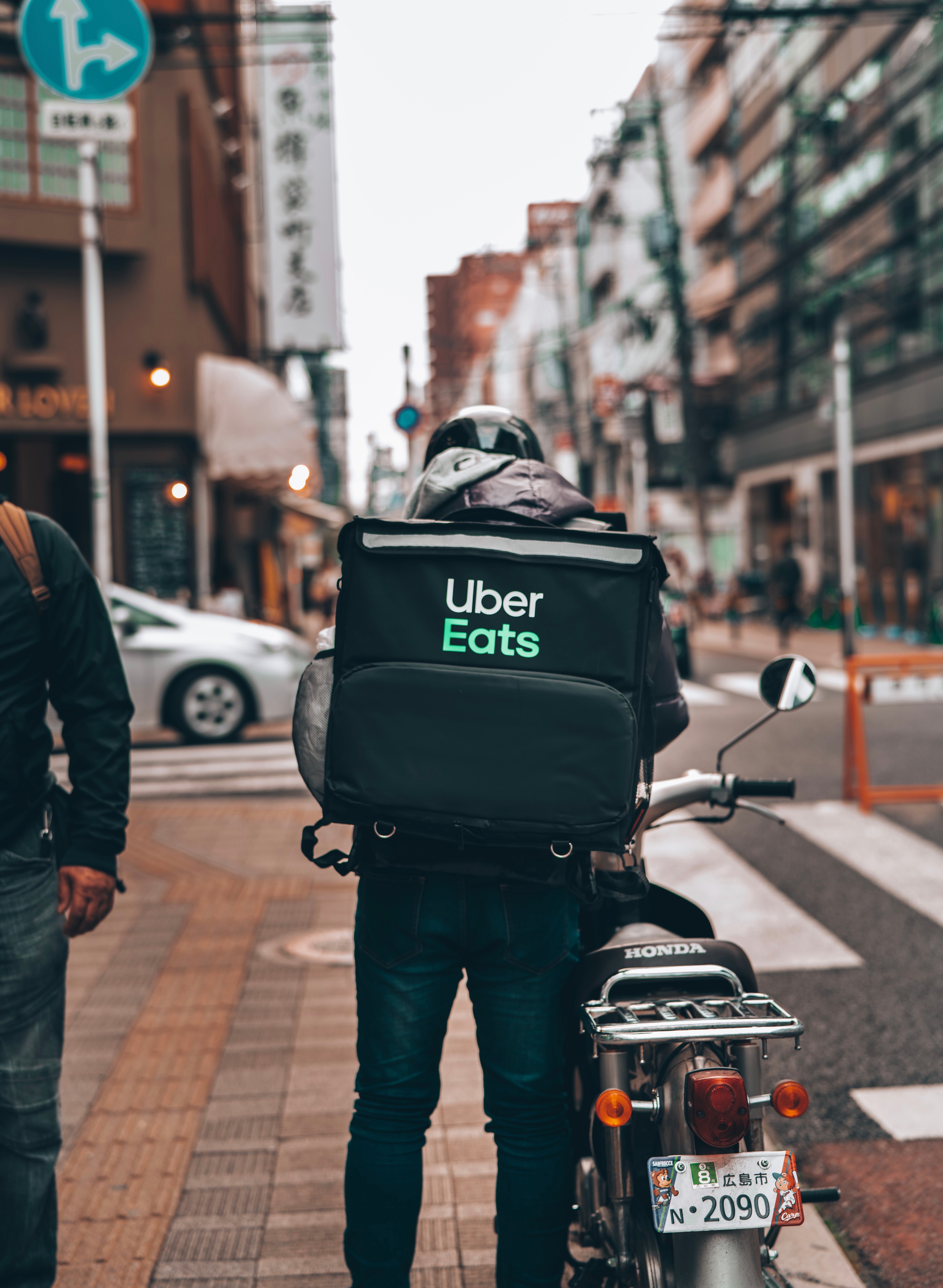 Image of a bicycle Uber Eats delivery person on a busy street