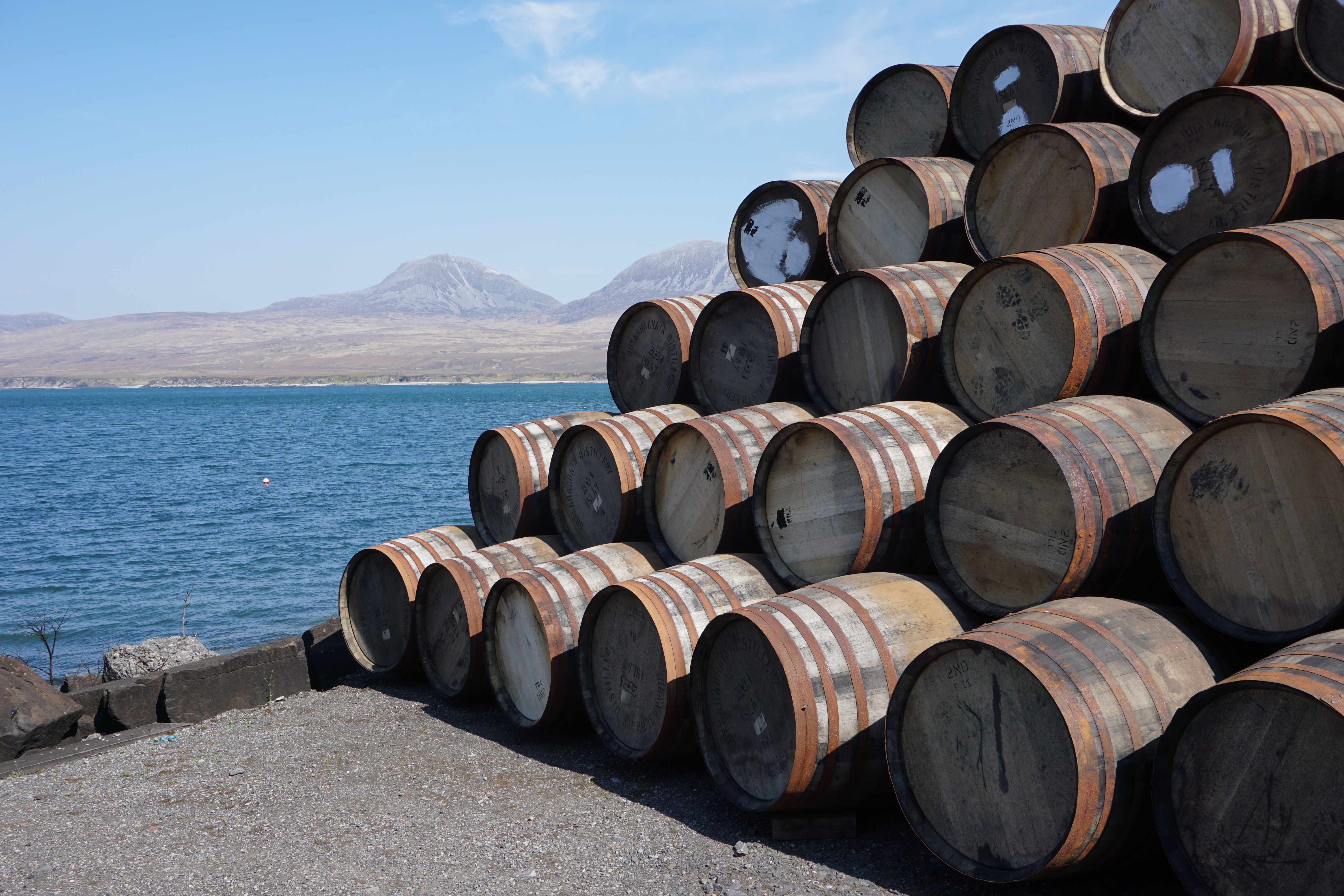 Whiskey barrels stacked together by the ocean