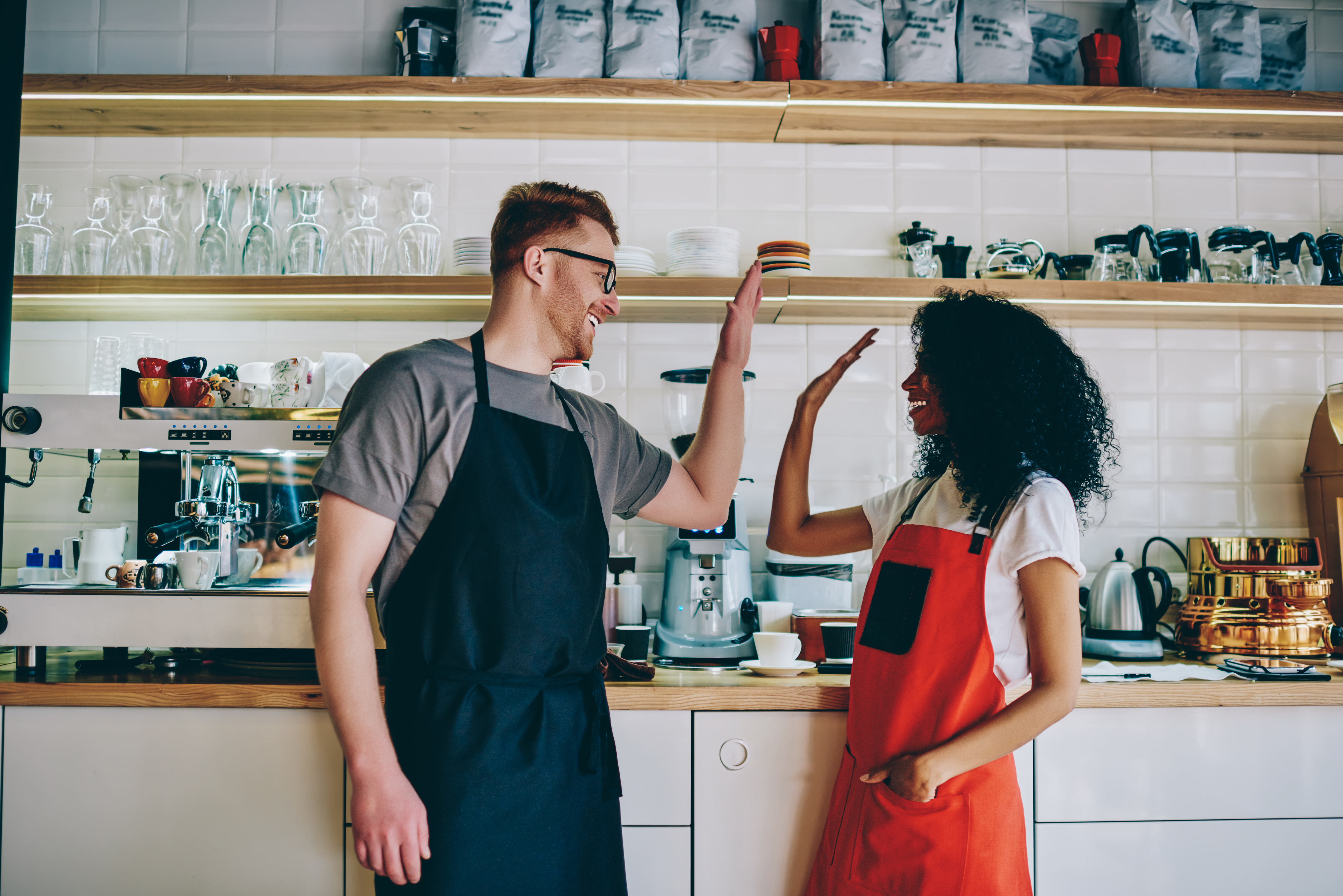 Bar and restaurant staff high five each other