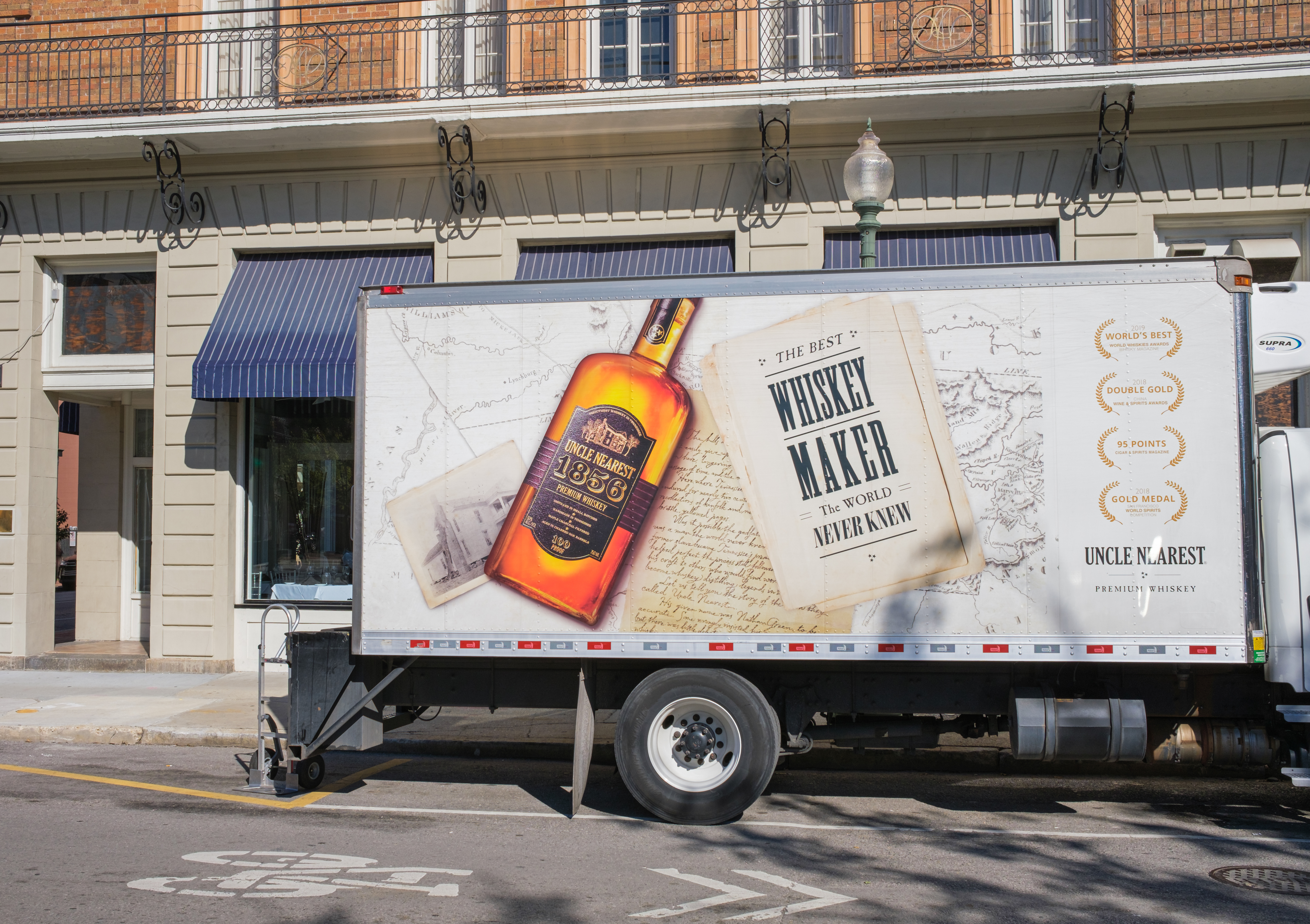 a box truck with an ad for Uncle Nearest whiskey