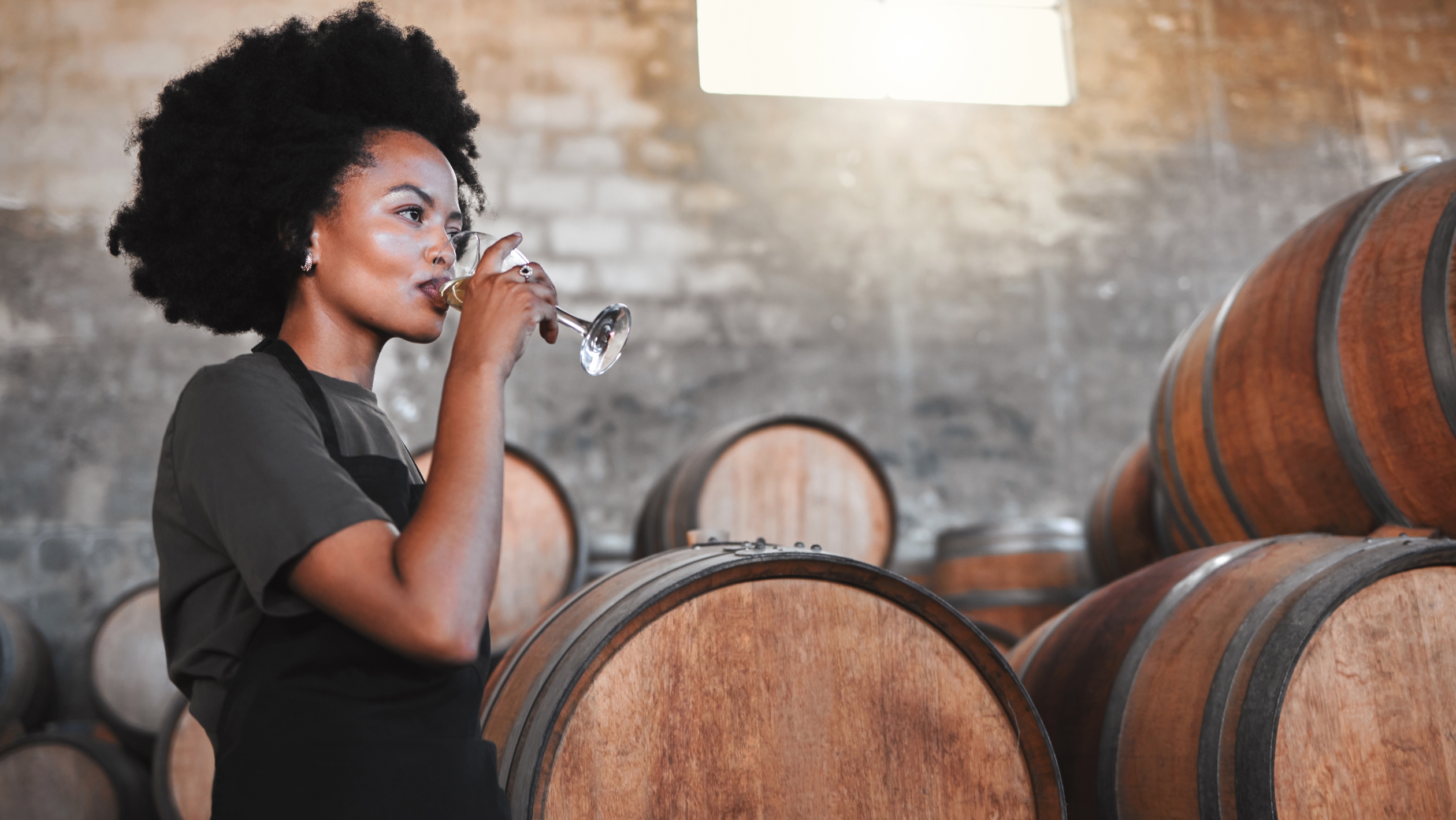 Woman drinking wine in a winery