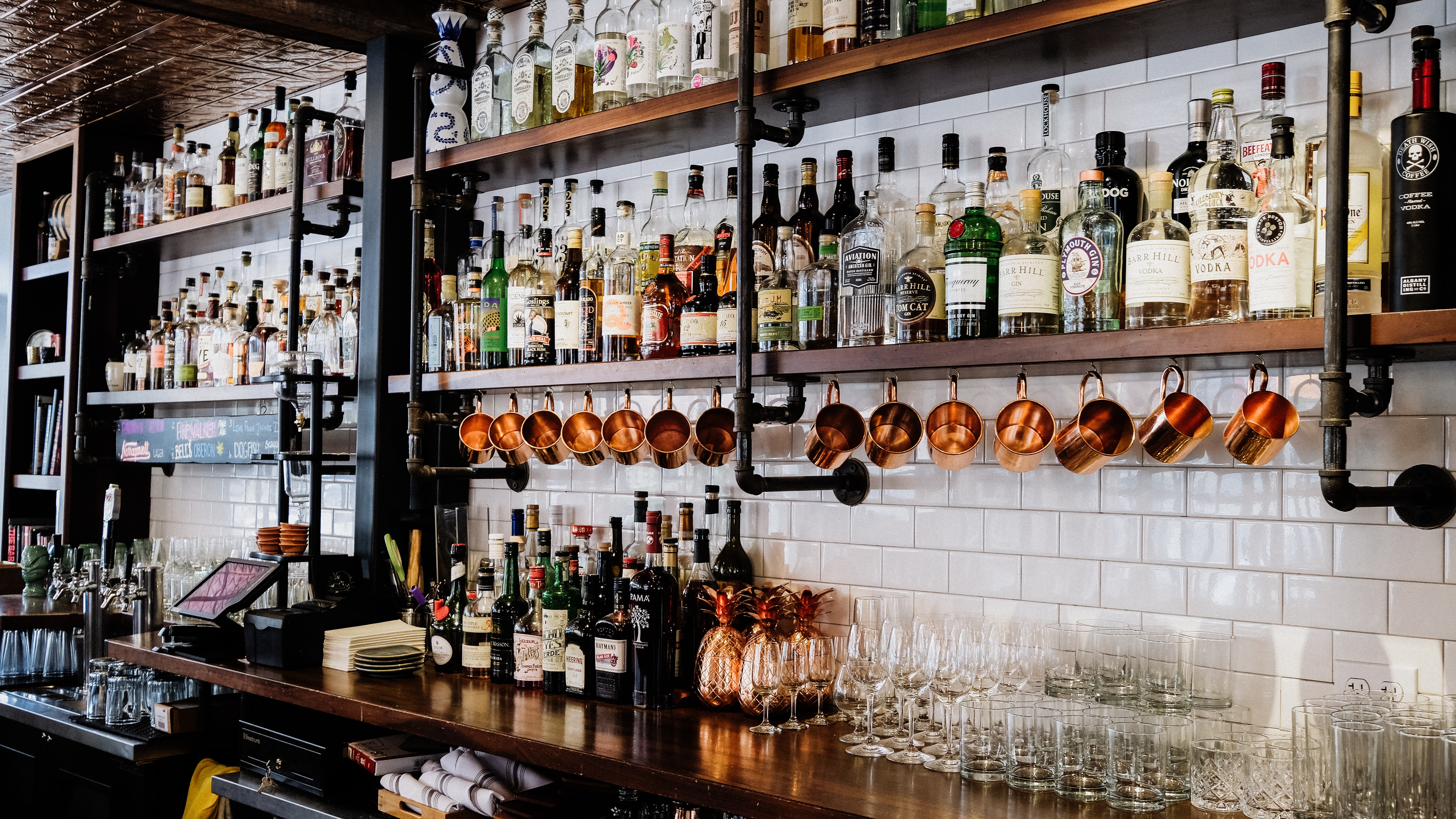 bottles of alcohol on the back bar at a restaurant