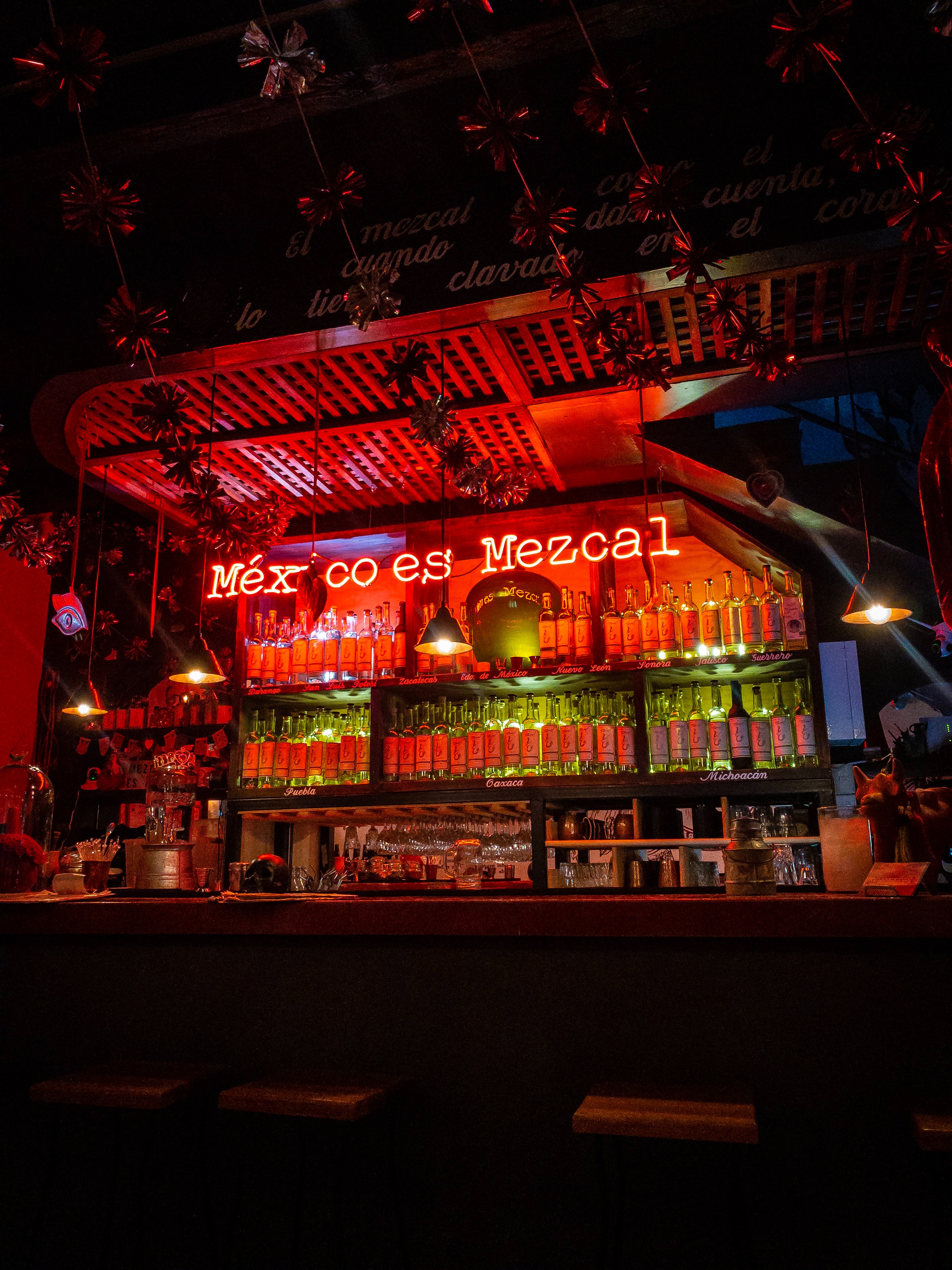 Neon lights illuminating a bar that read 