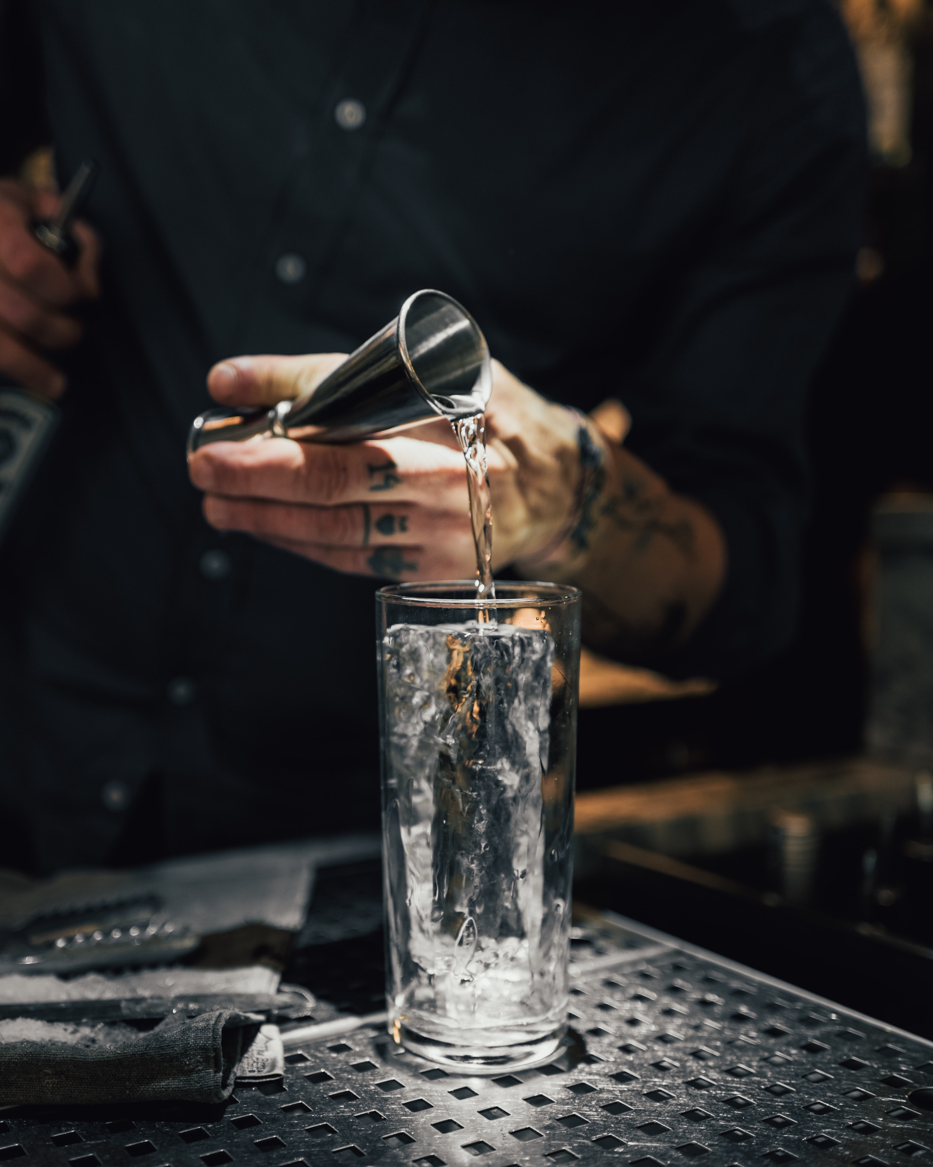 A bartender making a highball cocktail